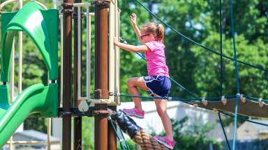 girl climbing rope at mary belle pate park