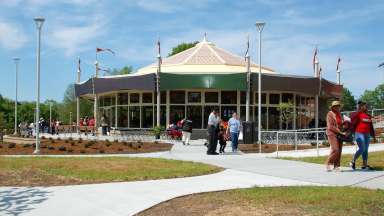 People walking outside chavis park carousel