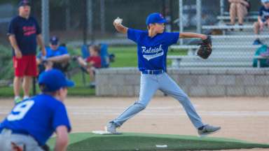 Youth baseball player pitching ball