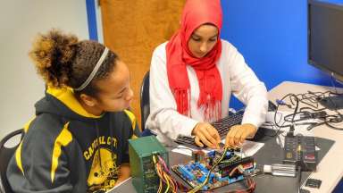 Girls working on motherboard