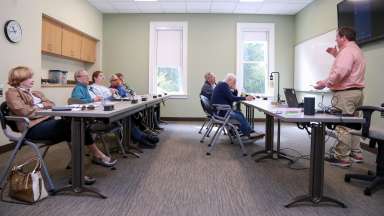 A group of adults in a classroom setting