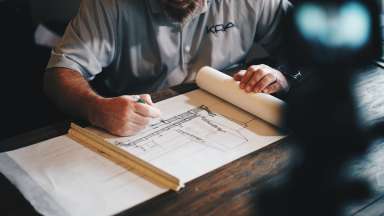 Man creating architecture drawing