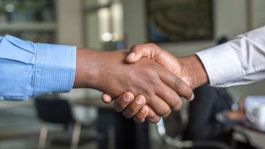 two black hands shaking hands