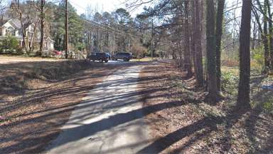 Aberdeen Drive, showing the roadway is not paved and lack of sidewalk.