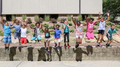 Cute kids jumping off wall