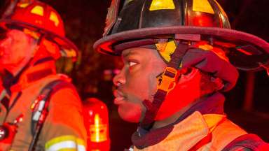 Firefighters standing side by side