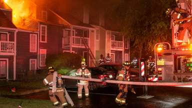 Firefighters attempting to put out fire at apartment building