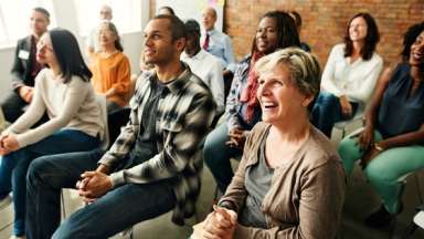 Diverse audience listens to speaker