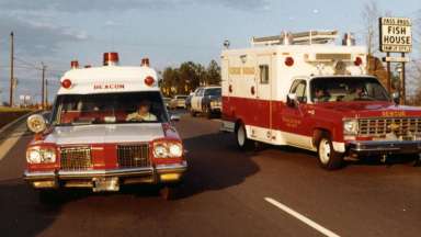 1970s-era fire apparatus driving down road