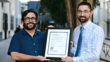 From left to right, Christopher Golden and John Anagnost, hold the 2022 NC Chapter of the American Planning Association’s Marvin Collins Award