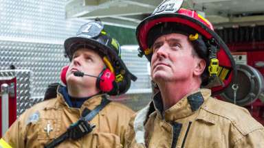 Two fire fighters evaluating the scene