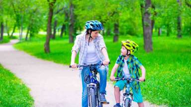 Mother and son biking on greenway