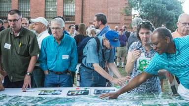 people at an event sharing ideas at an interactive planning table