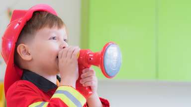 Young student dressed in firefighter costume.