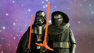 Darth Vader and friend with lightsabers  