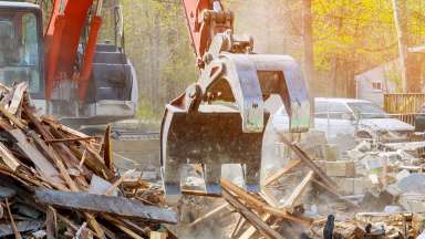 Demolition of an old house for new construction project.