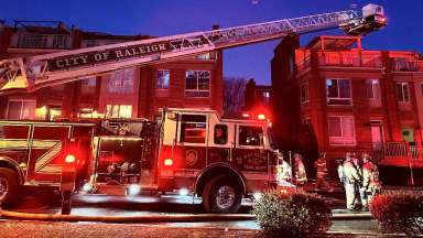 Raleigh Fire Department responds to a call. A ladder truck is sitting outside of an apartment building.