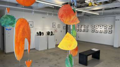 brightly colored hanging artworks in a gallery