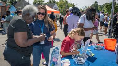 people talking at a table at the dmv site event