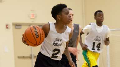 young basketball players on a fast break during a game