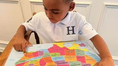 a young child enjoying learning about a map