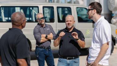 Group of people talking on a tour of the bioenergy facility