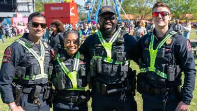 Four off-duty officers posing for the camera at an event.