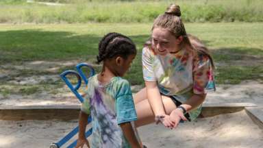 kid playing in sandbox