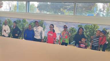 a painting of Barwell Road community members smiling