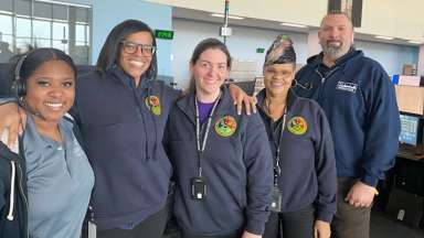 Five Emergency Communications call takers pose for the camera.