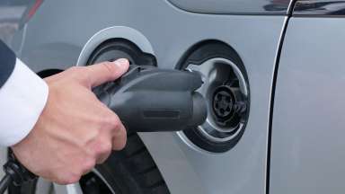 Electric vehicle charger plugging into car