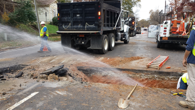 Raleigh water employees working on a sewer issue in the ground.