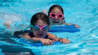 two kids swimming laps