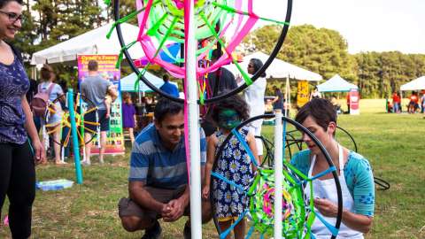 children and instructor creating decorated hoops at public event