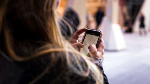 woman dialing smartphone stock communications