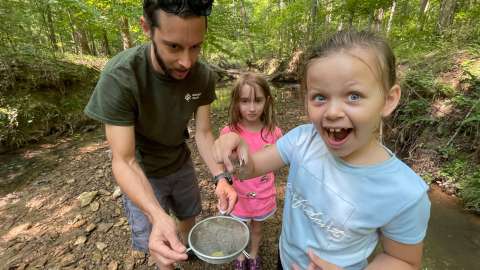 Wilkerson Natural Science Camp participant catching their first crayfish.