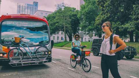 A bus and people walking and biking