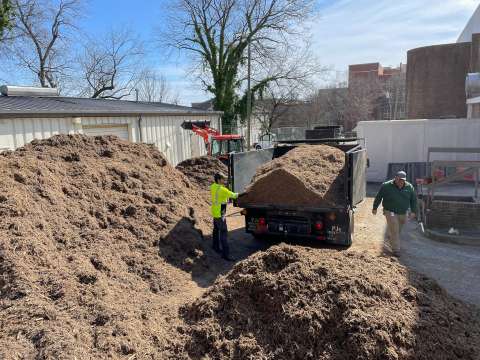 staff members loading mulch for delivery