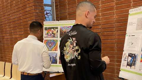 People looking at boards at a public meeting