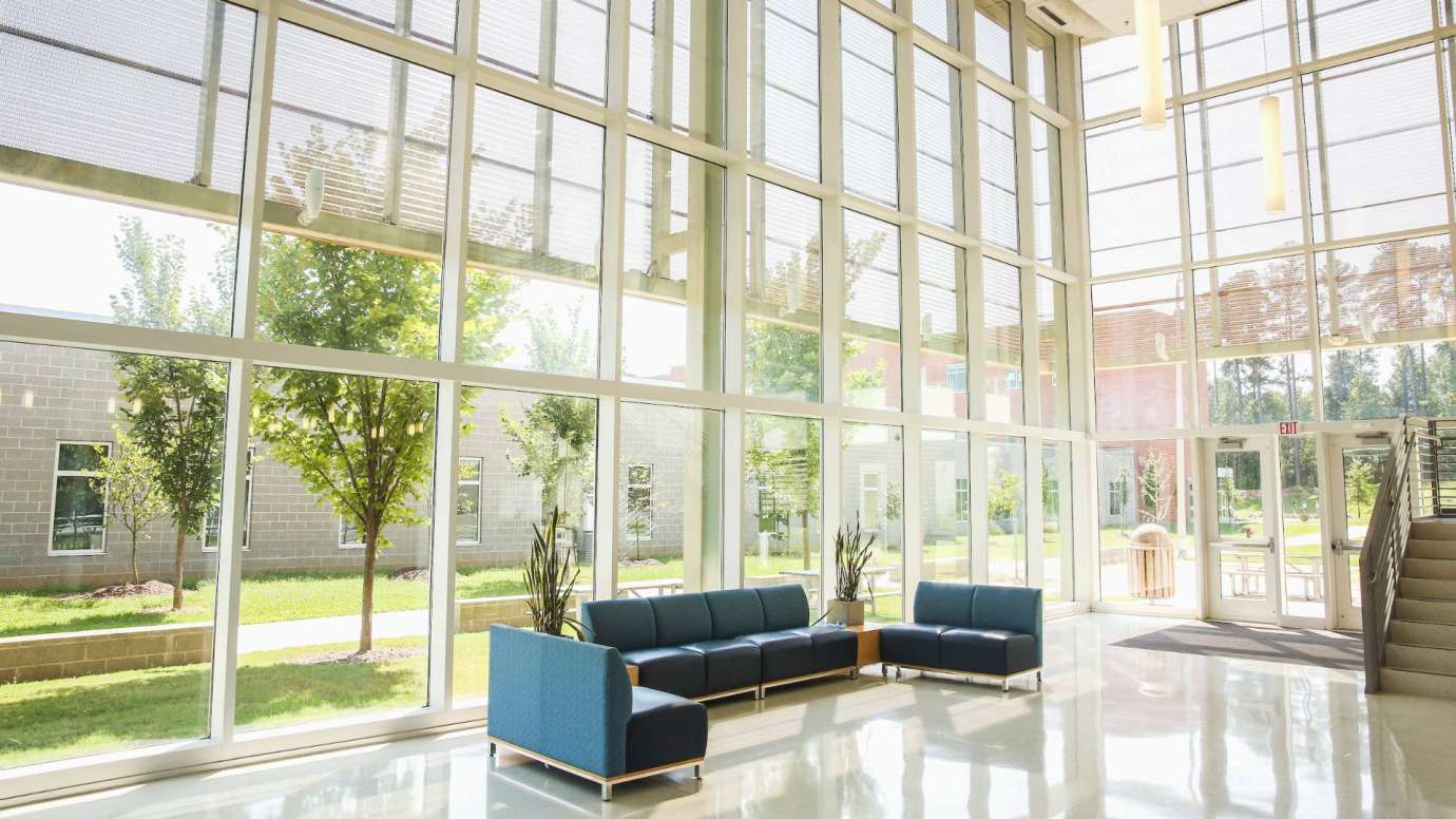 Seating area in glass-enclosed Abbotts Creek lobby