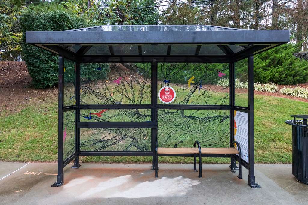 artwork by Leslie Bartlebaugh covering the windows of a bus shelter