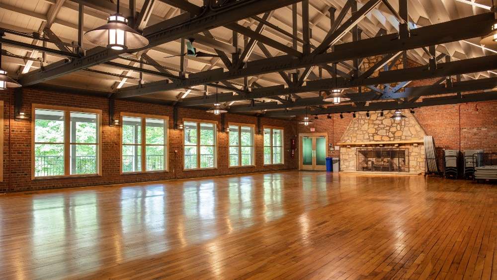 Interior view of Campbell lodge with large stone fireplace and hardwood floors