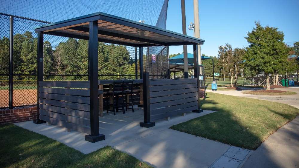 Covered scorekeeping area with scoreboard for each field 