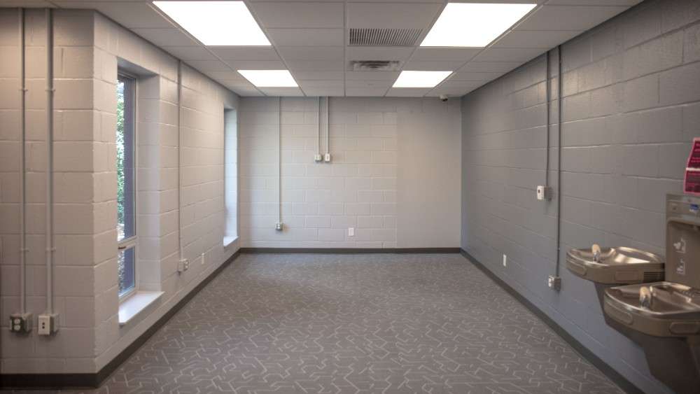 Interior room at Ralph Campbell community center with windows and water fountains