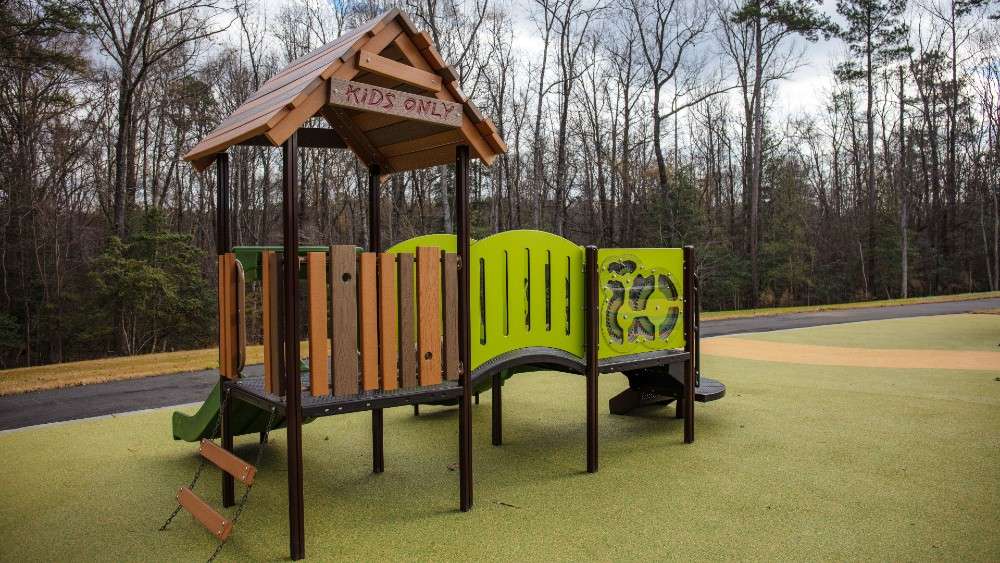 Playground structure with slides and sign that says "Kids Only"