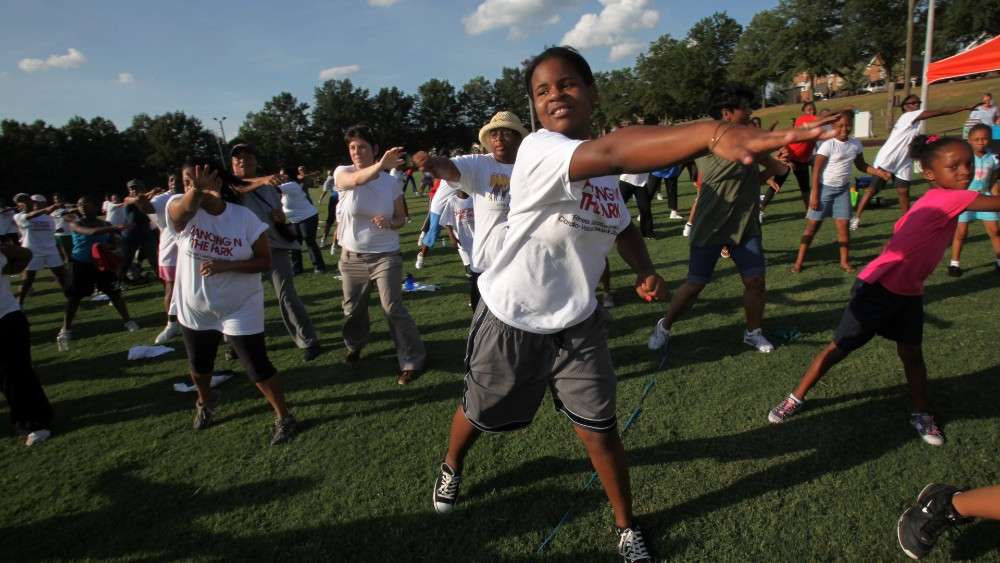 Kids dancing in field at John Chavis Memorial Park