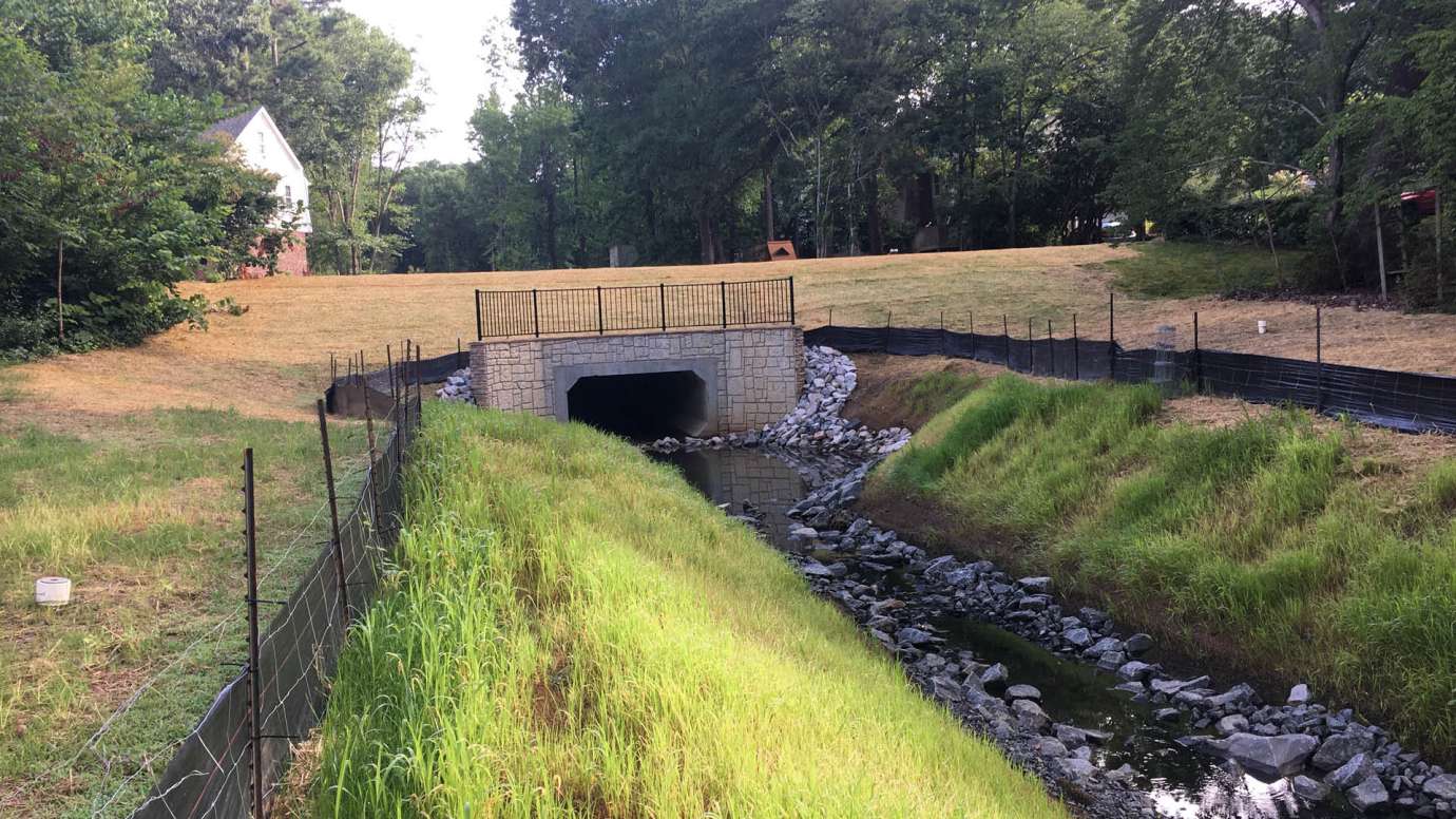 A concrete, rectangular culvert that carries water under Knights Way when it rains. 