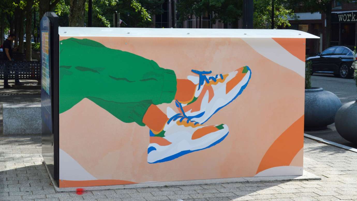 Artwork on a news rack kiosk that features legs with colorful sneaker shoes on