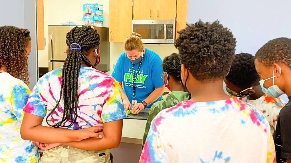 Students watch instructor show them how to pickle cucumbers