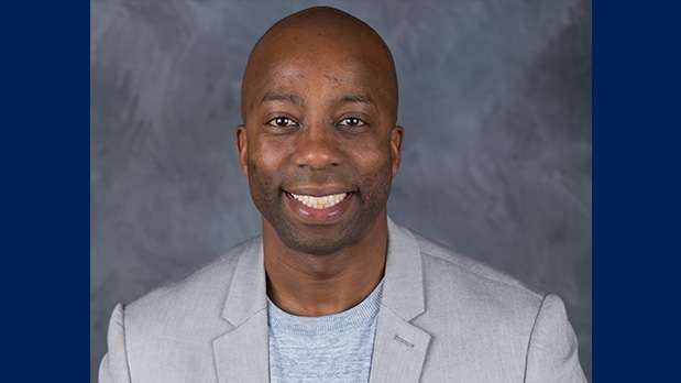 Man in blazer for head shot smiling